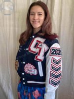 Detailed view of striped heavy-duty ribbed cuffs and waistband on a New Jersey pro-fit baseball varsity jacket.