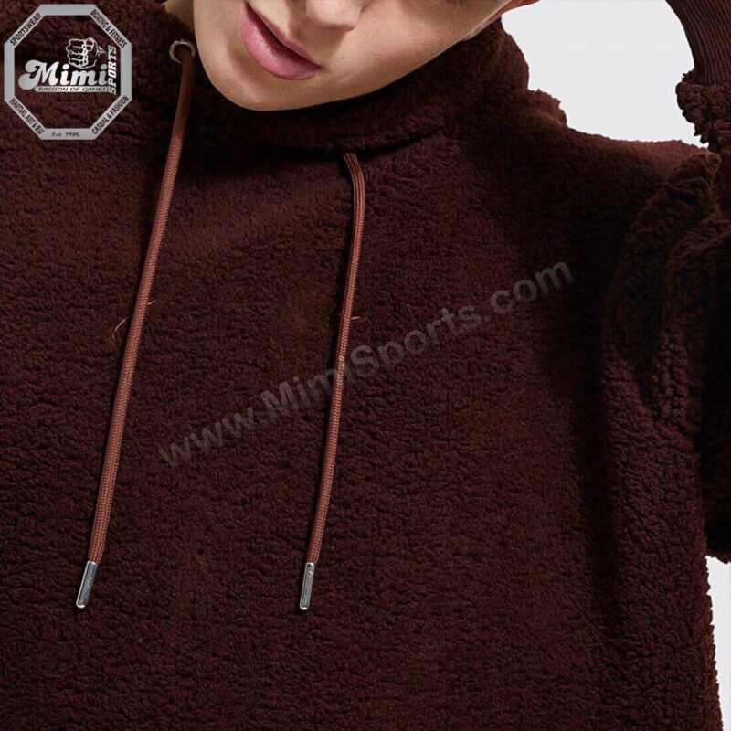 Technical view of MimiSports USA dark brown hoodie showing a high-stitch embroidery logo for a premium 3D finish.